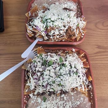 Chilaki's - Chilaquiles with red sauce, top plate with milanesa, and chorizo. Bottom plate with asada. - Mexican Near Me - Bakersfield, California