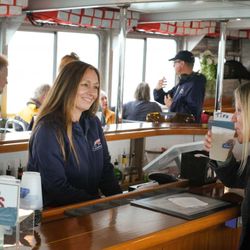 Conanicut Marine Services - Coastal Queen features a grand, teak wood bar that is centrally located in this spacious tour boat.