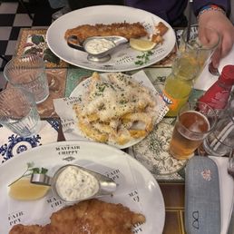 Hake and haddock with Parmesan truffle fries, Fanta and a beer Hake and haddock with Parmesan truffle fries, Fanta and a beer