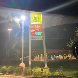 a gas station sign at night a gas station sign at night