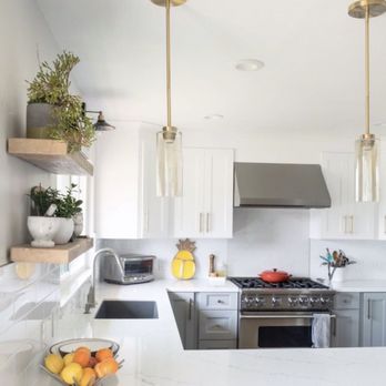 Centerstone Remodels - a kitchen with white cabinets and marble countertops - General Contractors Near Me - Gilbert, Arizona