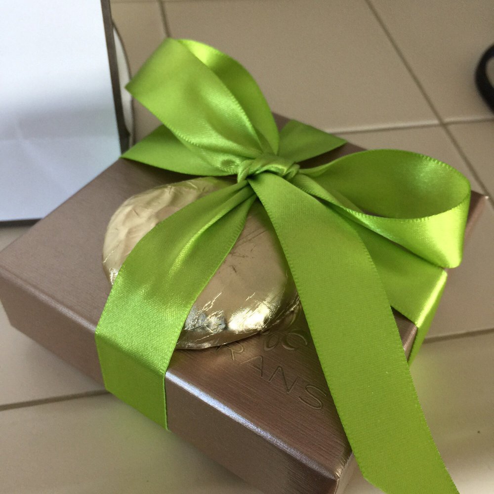 Small box of chocolate with a crushed, chocolate-dipped fig on top. Beautifully wrapped in-store.