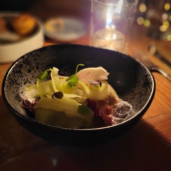 Burdock & Co - a bowl of food on a table - Tapas/Small Plates Near Me - Vancouver, British Columbia