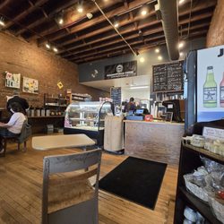 Sacred Grounds - Espresso machine, pastry case, and milk station