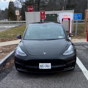 Hertz Rent A Car - Car parked at a Tesla charger. - Car Rental Near Me - Haverhill, Massachusetts Hertz Rent A Car - Car parked at a Tesla charger. - Car Rental Near Me - Haverhill, Massachusetts