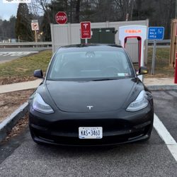 Hertz Rent A Car - Car parked at a Tesla charger.