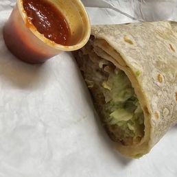 a burrito cut in half with sauce a burrito cut in half with sauce