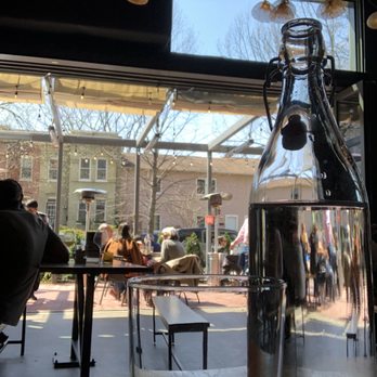 Shelter - a bottle of water sitting on a table in front of a window - Beer, Wine & Spirits Near Me - Washington, DC, District of Columbia