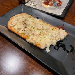 Roasted garlic chicken flatbread! Phone did not eat first (sorry). Roasted garlic chicken flatbread! Phone did not eat first (sorry).