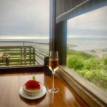 Moonstone Grill - The corner table for two offers an ocean view all around. - Seafood Near Me - Trinidad, California