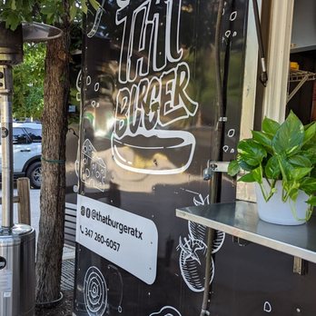 That Burger - a black food truck parked in front of a tree - Burgers Near Me - Austin, Texas