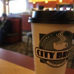 a cup of coffee on a table a cup of coffee on a table