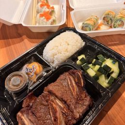 Togo items: short ribs bento box and sushi rolls Togo items: short ribs bento box and sushi rolls