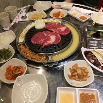 Mapo Korean BBQ - Ribeye on bbq grill with banchan - Barbeque Near Me - Toronto, Ontario Mapo Korean BBQ - Ribeye on bbq grill with banchan - Barbeque Near Me - Toronto, Ontario