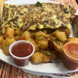 Boombergs Bagels Grill and Deli - Steak omelette. Hot sauce optional.