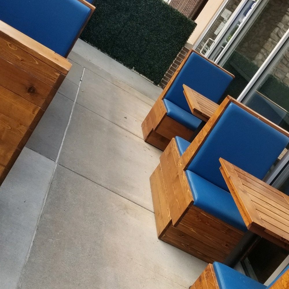 Tavern 180 - a row of wooden benches with blue cushions - American Near Me - Lincoln, Nebraska Tavern 180 - a row of wooden benches with blue cushions - American Near Me - Lincoln, Nebraska