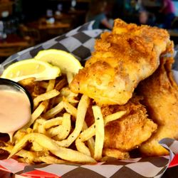 The Union Taproom and Restaurant - Golden, crispy beer battered cod piled high with hand cut fries, fresh lemon, and house made tartar sauce...