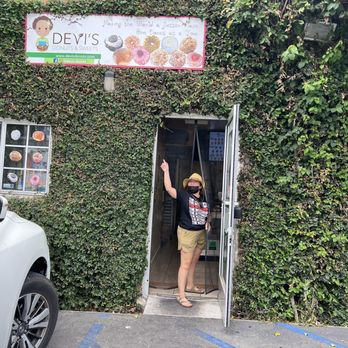 Devi's Donuts and Sweets - Pointing at the sign - Donuts Near Me - Long Beach, California