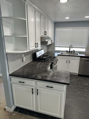Kitchen cabinet refinishing 2026 - The refinishing was done on some old cabinets, which we sanded down to the wood grain primer them, and painted them with cabinet paint and and brought the kitchen back to life