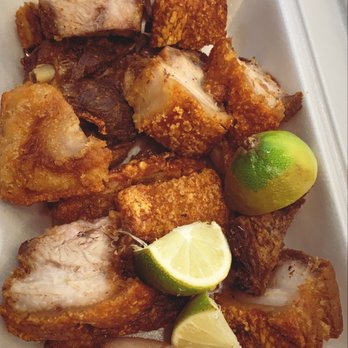 El Tipico Restaurant - a plate of chicken with lime wedges - Latin American Near Me - Lawrence, Massachusetts
