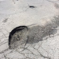 Crossing Bridge Square - Please please please! Fix these awful pot holes! Nearly swallowed up the entire car!!