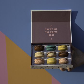 Woops! - a person holding a box of macarons - Desserts Near Me - Providence, Rhode Island