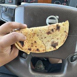 a person holding a piece of food a person holding a piece of food