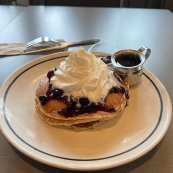 Corner Bakery Cafe - a stack of pancakes with whipped cream and jam - Bakeries Near Me - Shorewood, Wisconsin
