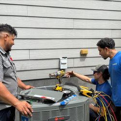 Kenny Fowler Heating & Air - Carolina Comfort Air technicians working together to complete a residential HVAC installation. Each system is carefully installed, connected