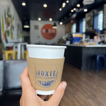 Moxie Coffee Company - a hand holding a coffee cup - Coffee & Tea Near Me - Seymour, Indiana Moxie Coffee Company - a hand holding a coffee cup - Coffee & Tea Near Me - Seymour, Indiana