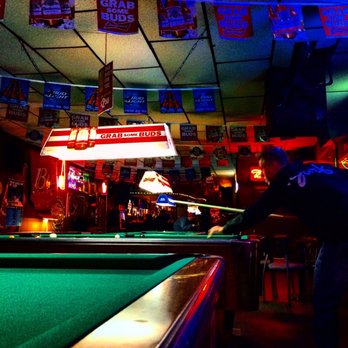 Catalina Lounge - a man playing pool in a bar - Dive Bars Near Me - San Diego, California