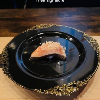 Mottsu - a piece of salmon on a black plate - Japanese Near Me - Brooklyn, New York
