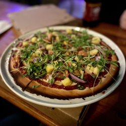Ciao Down - BBQ Jack Vegan Pizza on Gluten Free dough. Jackfruit, pinapple, jalapeño, red onion, vegan mozzarella, micro cilantro and BBQ sauce.