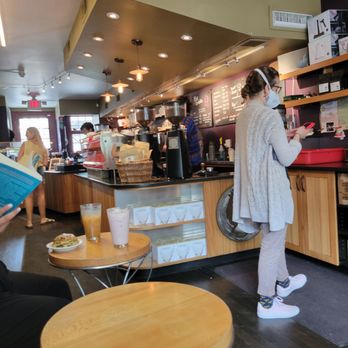 Rojo's Roastery - a woman reading a menu - Coffee Roasteries Near Me - Princeton, New Jersey