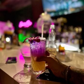 Astoria Gramercy Caf3 - a person holding a drink at a bar - Cafes Near Me - Astoria, New York Astoria Gramercy Caf3 - a person holding a drink at a bar - Cafes Near Me - Astoria, New York