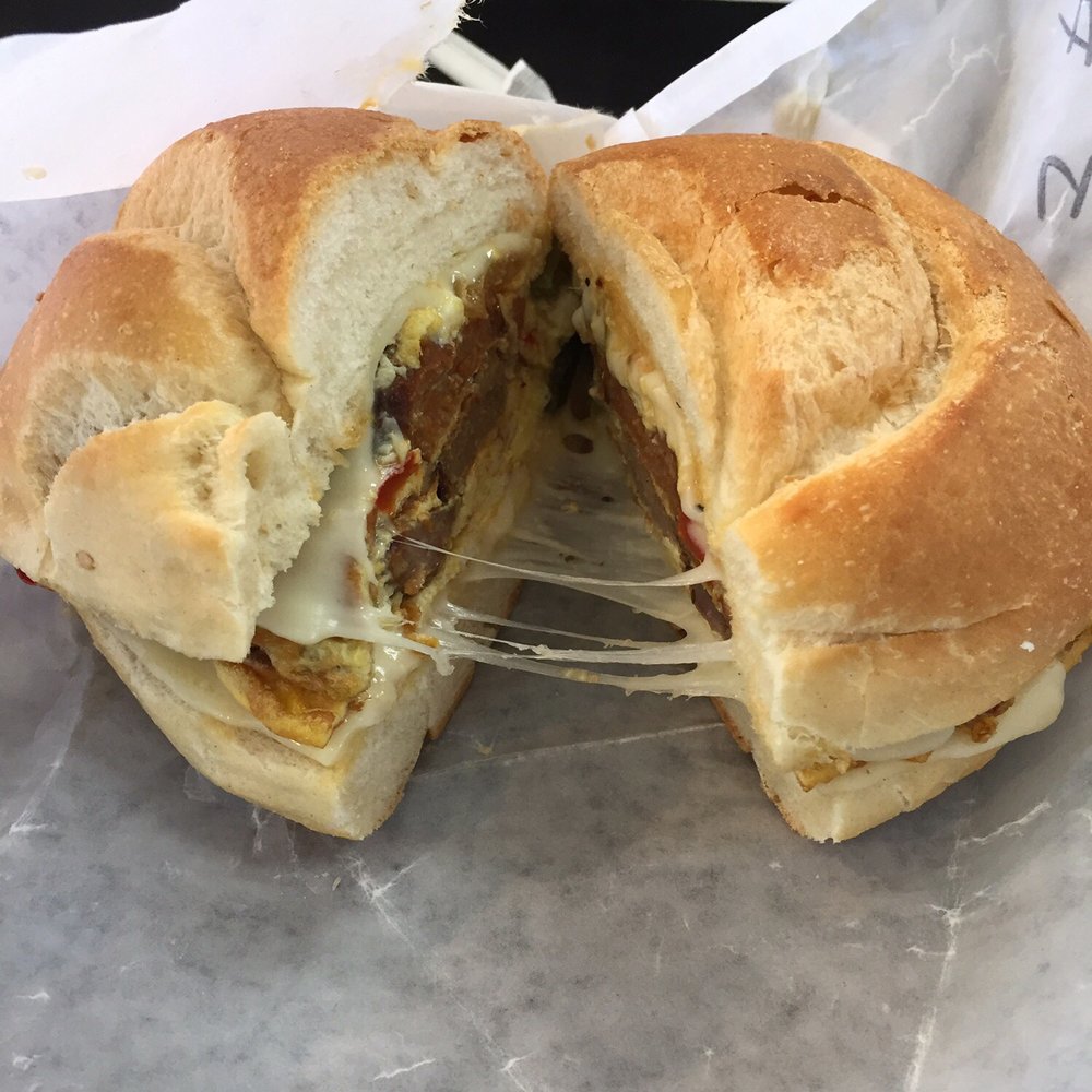 Tasty sausage, peppers, and egg with gooey mozzarella cheese on a soft roll makes this sandwich a winner