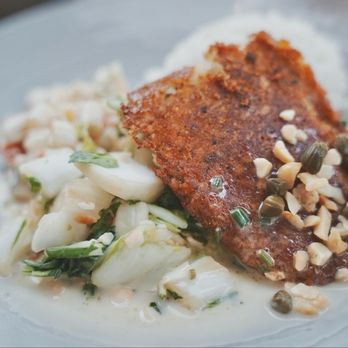 Duke's La Jolla - Sautéed Mac Nut & Herb Crusted Fresh Fish. It's a mild flavored fish; crispy exterior surface, but flaky and tender inside. - New American Near Me - La Jolla, California