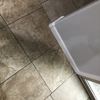 Express Flooring - Two rooms with mismatched grout lines.Right next to each other. It's the first thing that people notice when they come into our house. - Flooring Near Me