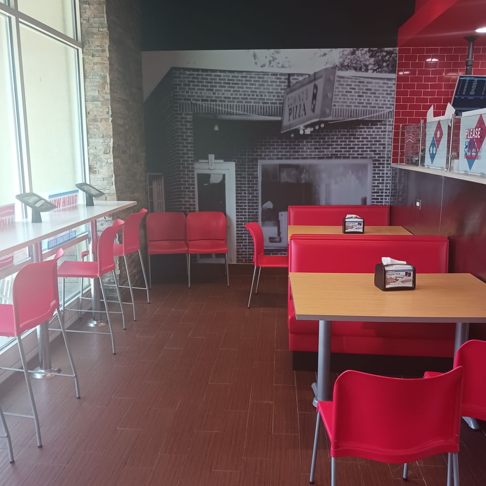 a dining area with red chairs and tables a dining area with red chairs and tables