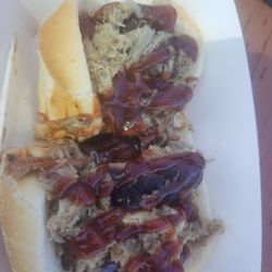 The Man BBQ Food Truck - Bacon wrapped hotdogs topped with pulled pork and bbq sauce.