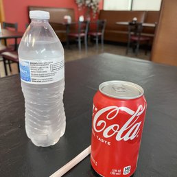 a soda and a pencil on a table a soda and a pencil on a table