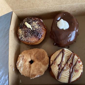 Wake N Bake Donuts - Top left: blueberry cheesecake, top right: chocolate cream filled, bottom left: cinnamon cream cheese, bottom right: elvis - Donuts Near Me - Carolina Beach, North Carolina Wake N Bake Donuts - Top left: blueberry cheesecake, top right: chocolate cream filled, bottom left: cinnamon cream cheese, bottom right: elvis - Donuts Near Me - Carolina Beach, North Carolina