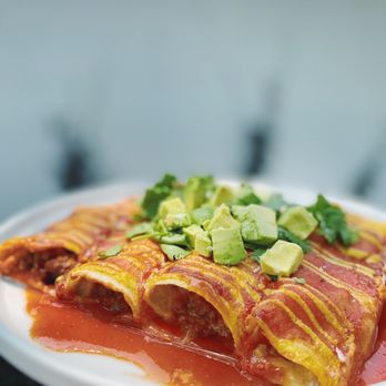 Real Food - a person holding a plate of enchiladas - Food Delivery Services Near Me - Dalton, Georgia Real Food - a person holding a plate of enchiladas - Food Delivery Services Near Me - Dalton, Georgia