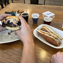 a person eating a sandwich at a table