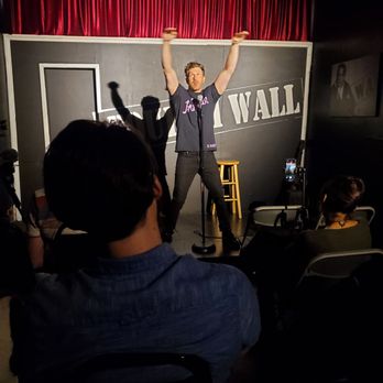 The Fourth Wall - a man standing on a stage with his arms in the air - Comedy Clubs Near Me - Los Angeles, California The Fourth Wall - a man standing on a stage with his arms in the air - Comedy Clubs Near Me - Los Angeles, California