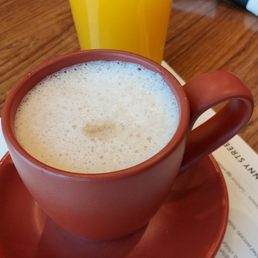 A caramel latte and fresh squeezed orange juice. A caramel latte and fresh squeezed orange juice.