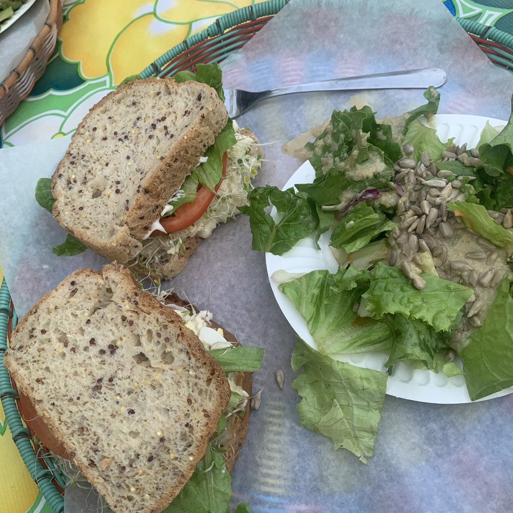 Whole egg salad sandwich on gluten free bread with a side salad & housemade tahini dressing.