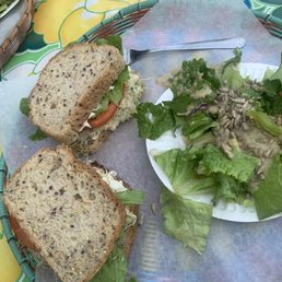 Whole egg salad sandwich on gluten free bread with a side salad & housemade tahini dressing.