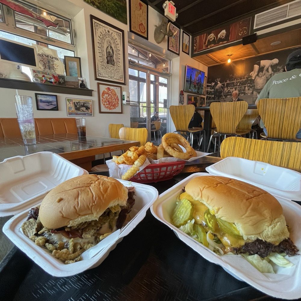 Jewboy Burgers - The A$$hole from El Paso Burger (left), The Jewboy Burger (right), fries, onion rings, view from inside the restaurant - Burgers Near Me - Austin, Texas Jewboy Burgers - The A$$hole from El Paso Burger (left), The Jewboy Burger (right), fries, onion rings, view from inside the restaurant - Burgers Near Me - Austin, Texas