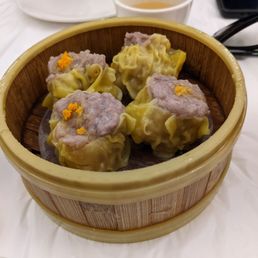 a wooden basket filled with dumplings a wooden basket filled with dumplings